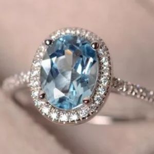 SILVER BLUE AND WHITE TOPAZ OVAL SHAPED HALO RING